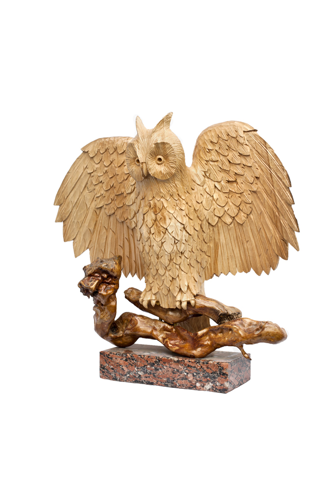 lime tree wood sculpture long-eared owl spread wings sitting branch