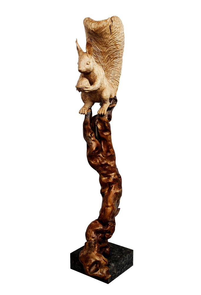 squirrel holding nut sitting branch animal sculpture